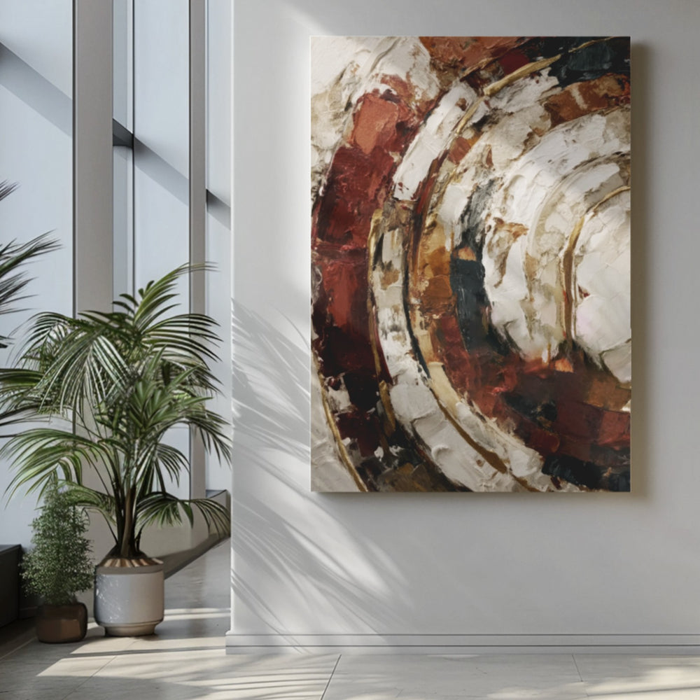 Terracotta arcs abstract canvas wall art in rust and cream in a bright entryway beside a potted palm